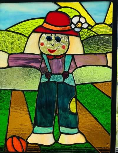 Colourful stained glass Scarecrow art panel framed in zinc