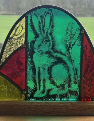 Stained glass hare on a wooden base