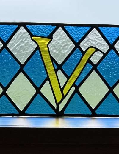 Leaded window in blue and clear with V letter