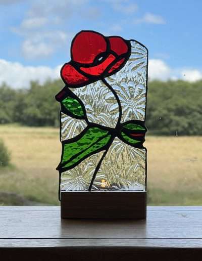 Stained glass poppy tea light holder on a wooden oak base