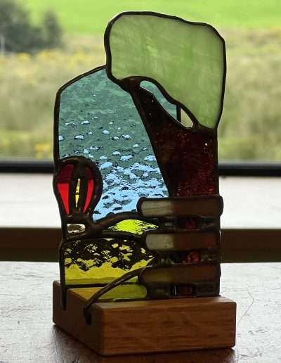 Stained glass balloon ornament on wooden base