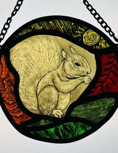 Hand painted stained glass sun catcher of an Autumn squirrel