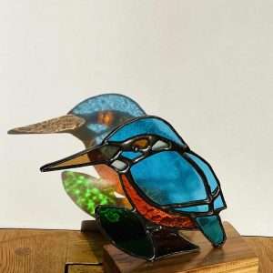 Stained glass kingfisher bird ornament on a wooden base